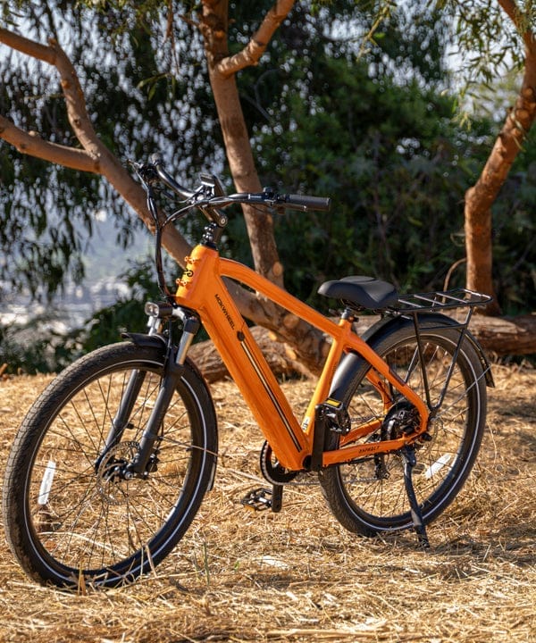Orange Mokwheel e-bike parked on a wooded North Florida trail
